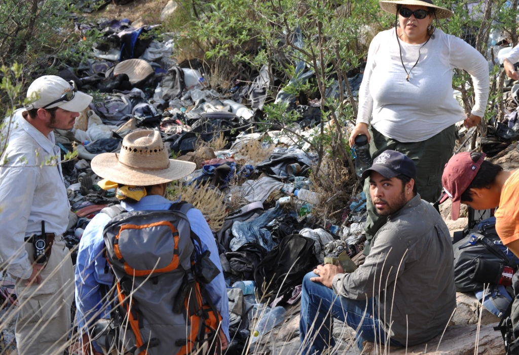 De Len, seated at right, with his team at a large site of discarded objects near the US-Mexico border. Undocumented Migration Project (30200)